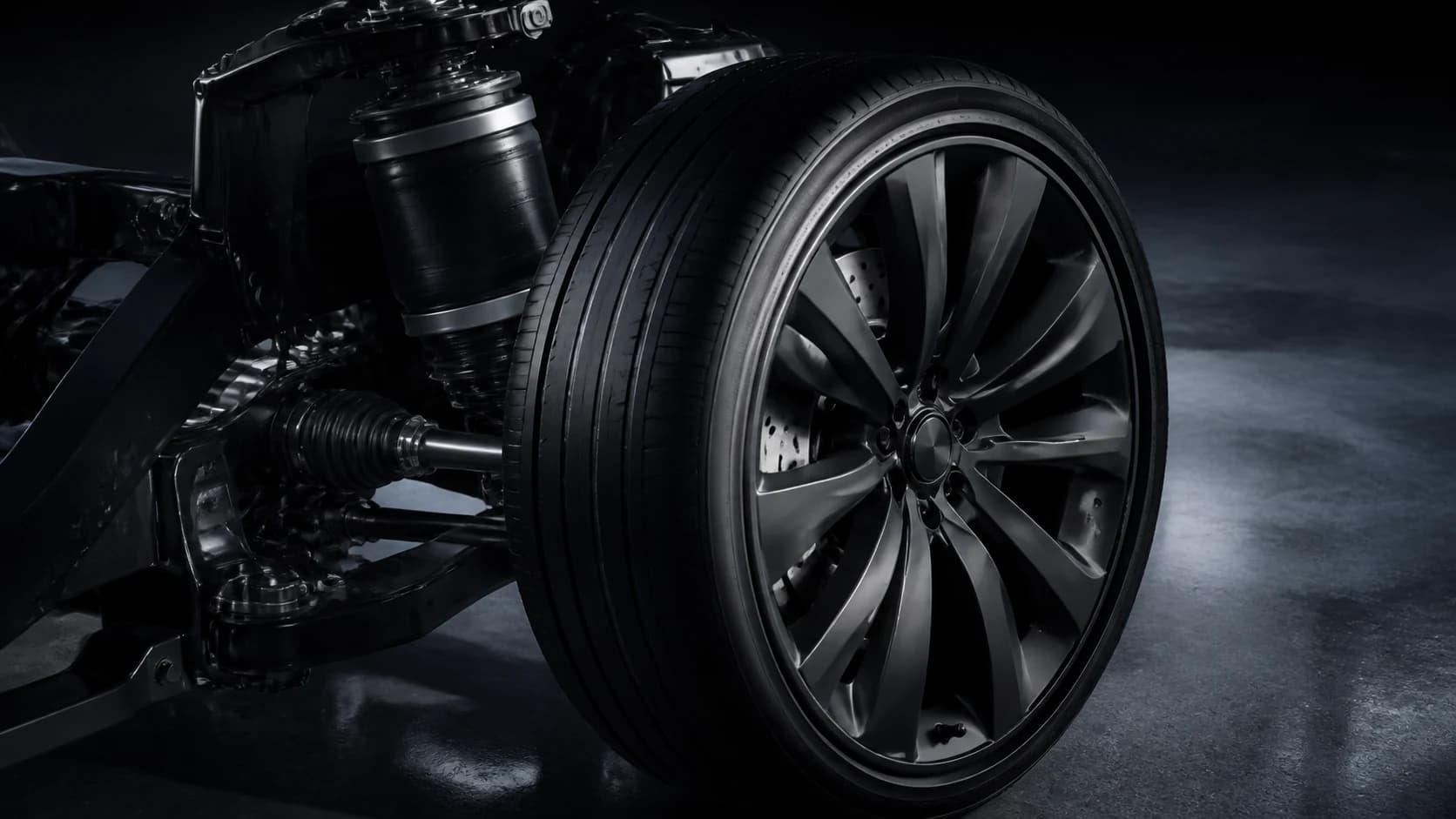 Close view of the Vantor's 21-inch Vector wheel and adaptive air suspension strut